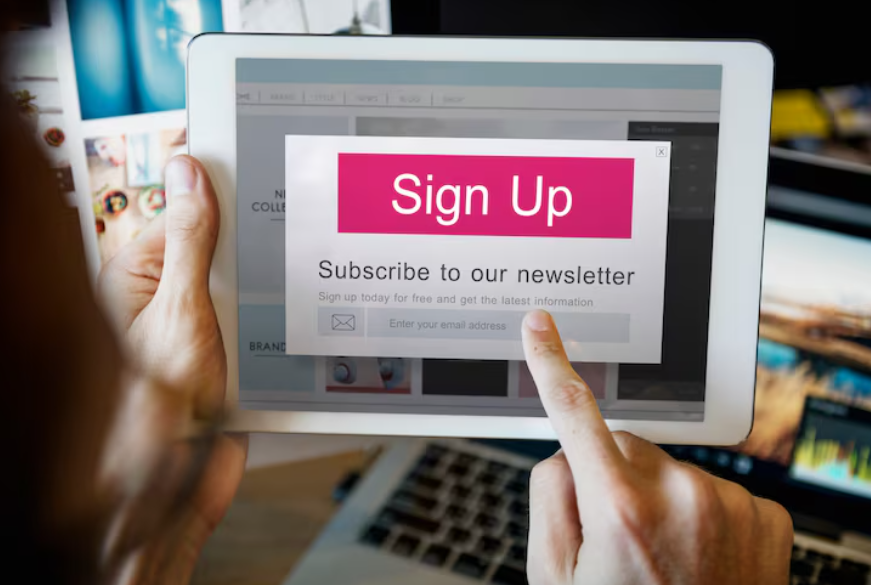 person subscribing to an email newsletter on tablet