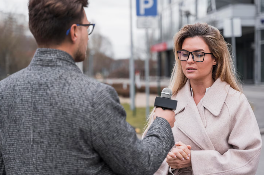 journalist interviewing woman on city street, illustrating empathy in storytelling