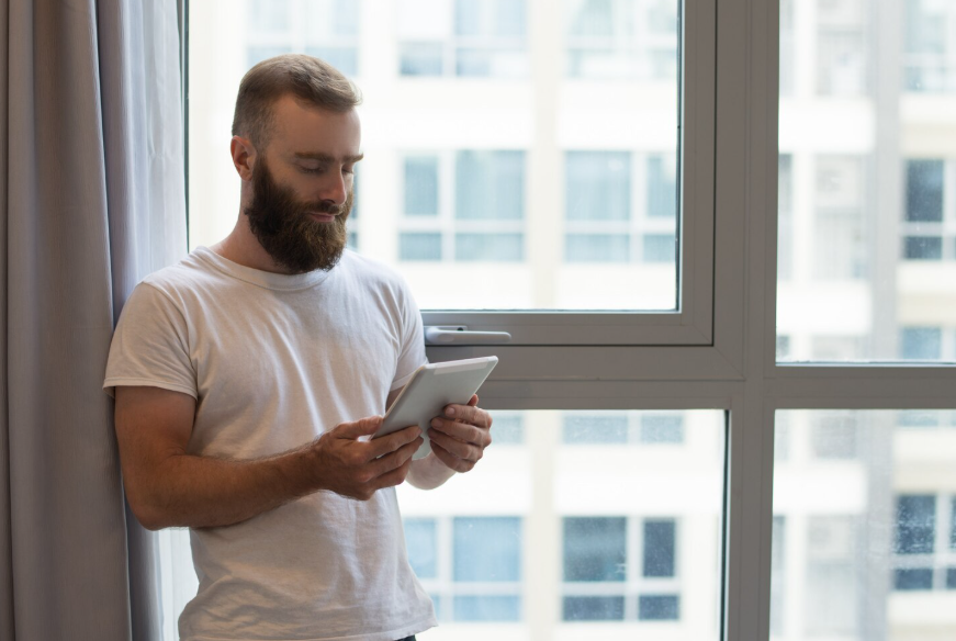 person reading hopeful stories in the news on a tablet at home